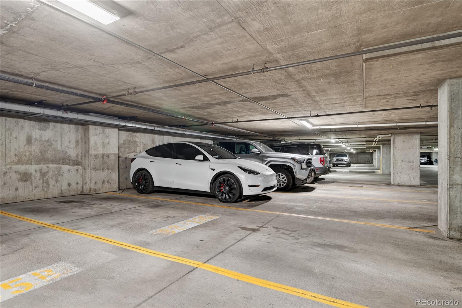 1401 Wewatta Street, Unit 305 Denver, CO 80202 - Photo 37 of 45 a view of parking garage with cars