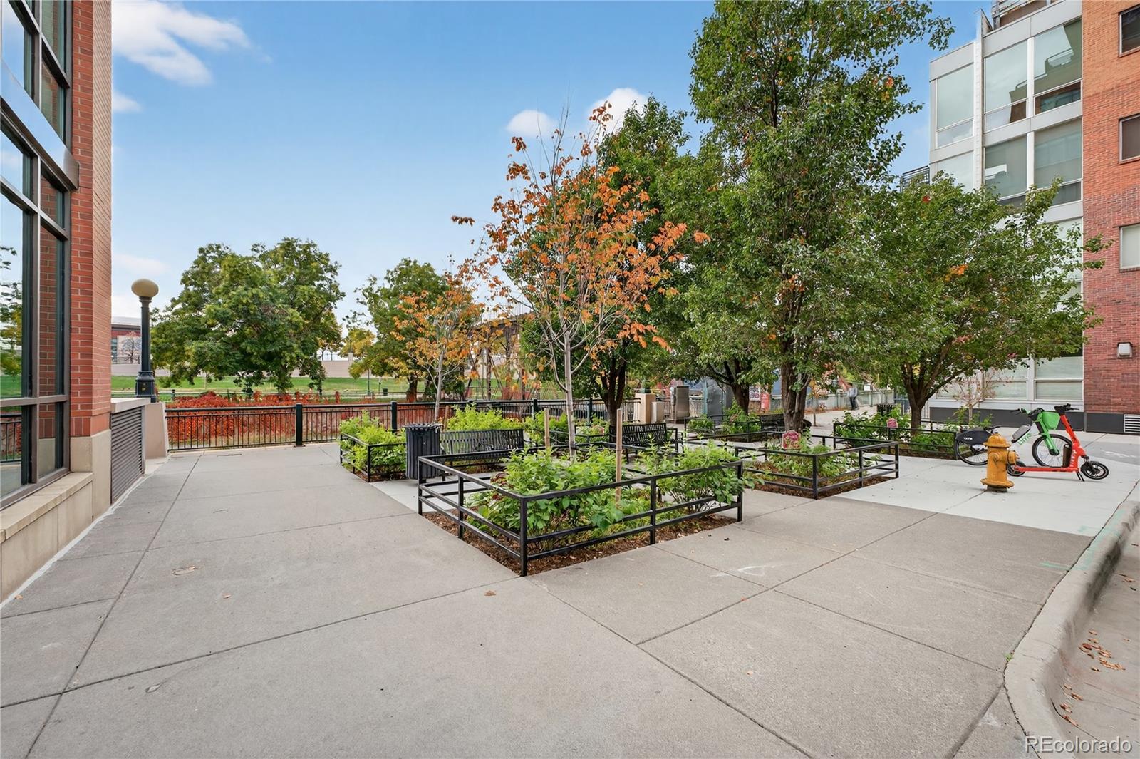 1401 Wewatta Street, Unit 305 Denver, CO 80202 - Photo 10 of 45 a view of a patio with table and chairs and potted plants