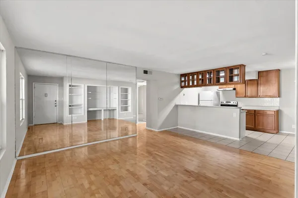 a view of a kitchen with a sink and a refrigerator