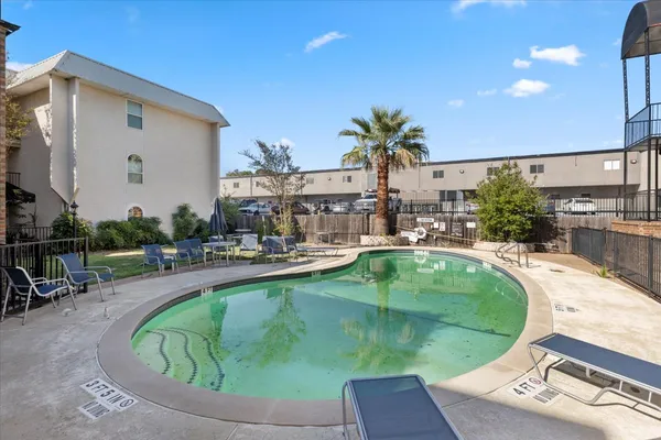 a swimming pool with outdoor seating and yard