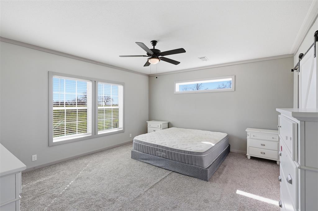 151 Private Road 3814 Springtown, TX 76082 - Photo 13 of 29 a spacious bedroom with a bed and a window