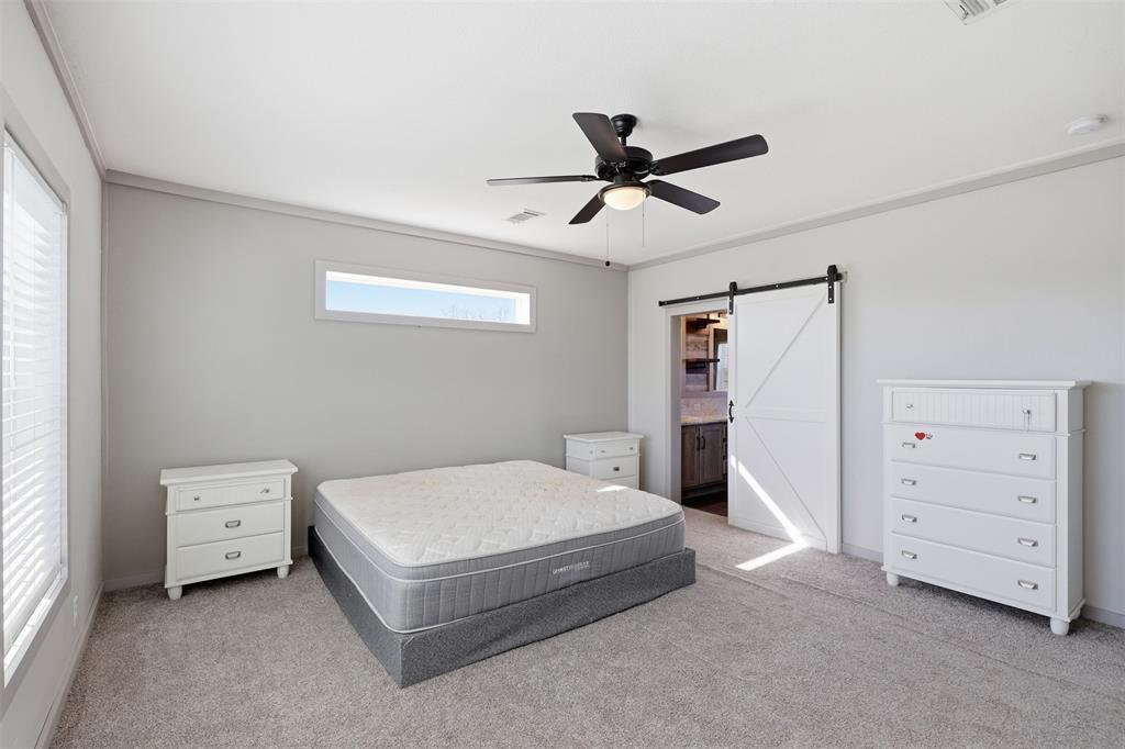 151 Private Road 3814 Springtown, TX 76082 - Photo 14 of 29 a spacious bedroom with a bed and a window