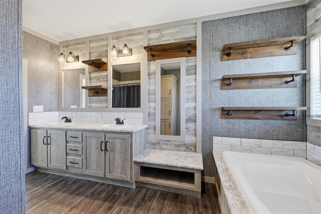 151 Private Road 3814 Springtown, TX 76082 - Photo 18 of 29 a bathroom with a double vanity sink a mirror and a bathtub