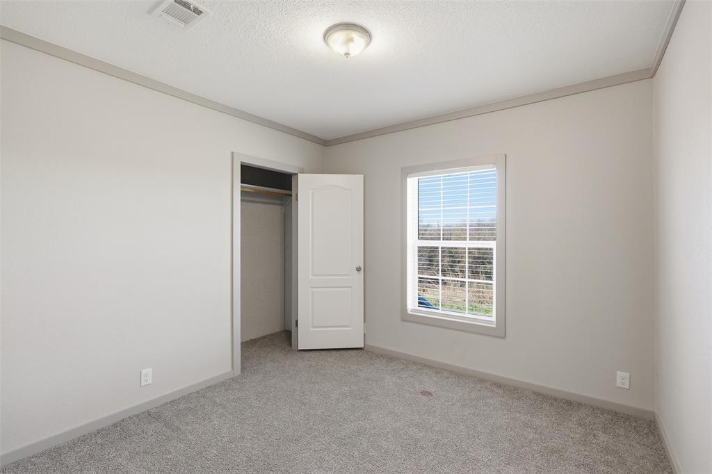 151 Private Road 3814 Springtown, TX 76082 - Photo 22 of 29 an empty room with windows