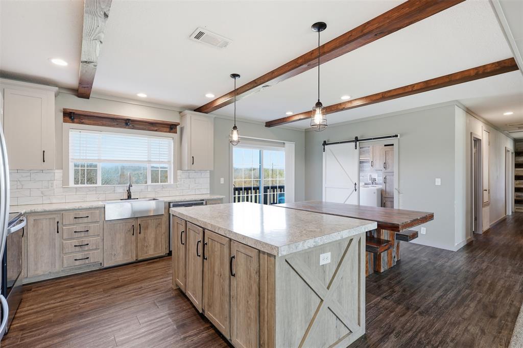 151 Private Road 3814 Springtown, TX 76082 - Photo 6 of 29 a kitchen with sink stove and wooden floor