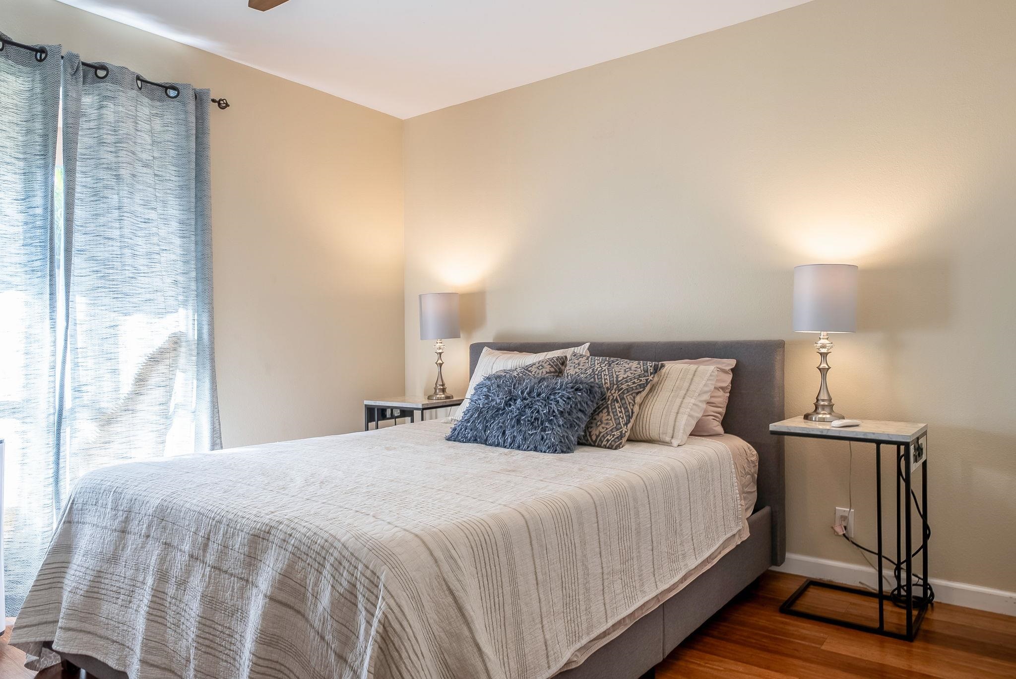 480 Kenolio Road, Unit 6204 Kihei, HI 96753 - Photo 21 of 44 a bedroom with a bed and a night stand