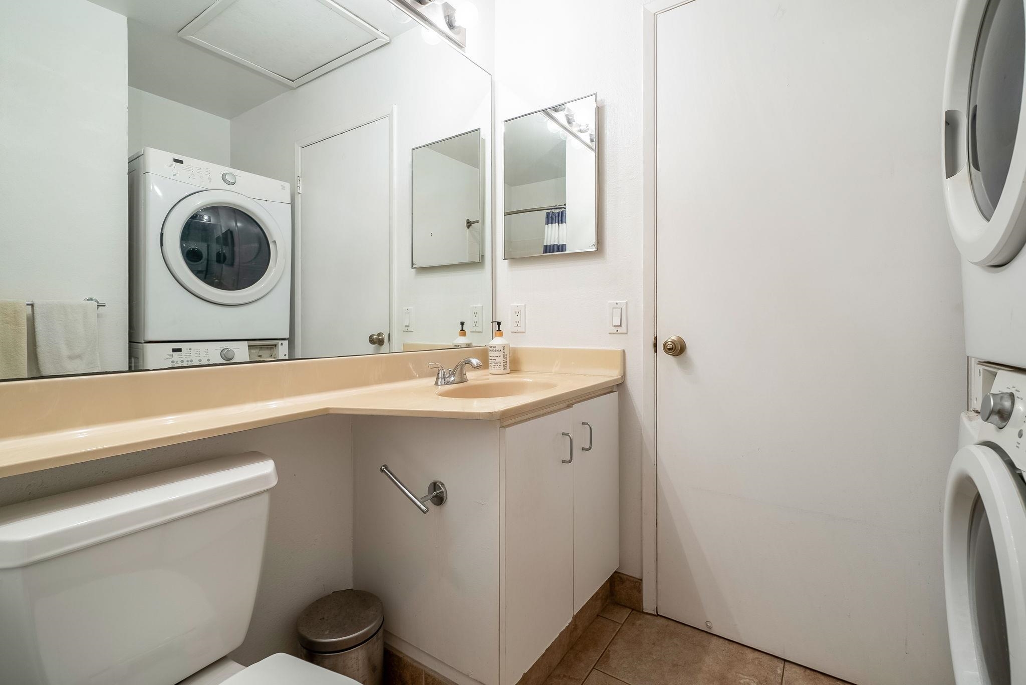 480 Kenolio Road, Unit 6204 Kihei, HI 96753 - Photo 28 of 44 a bathroom with a sink a toilet and a mirror