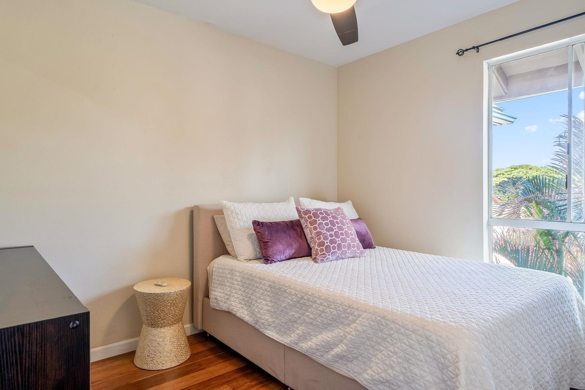 480 Kenolio Road, Unit 6204 Kihei, HI 96753 - Photo 31 of 44 a bedroom with a bed and painting on the wall