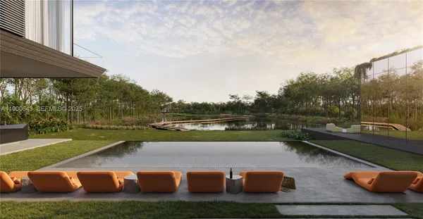 a view of a lake with lawn chairs and a large tree