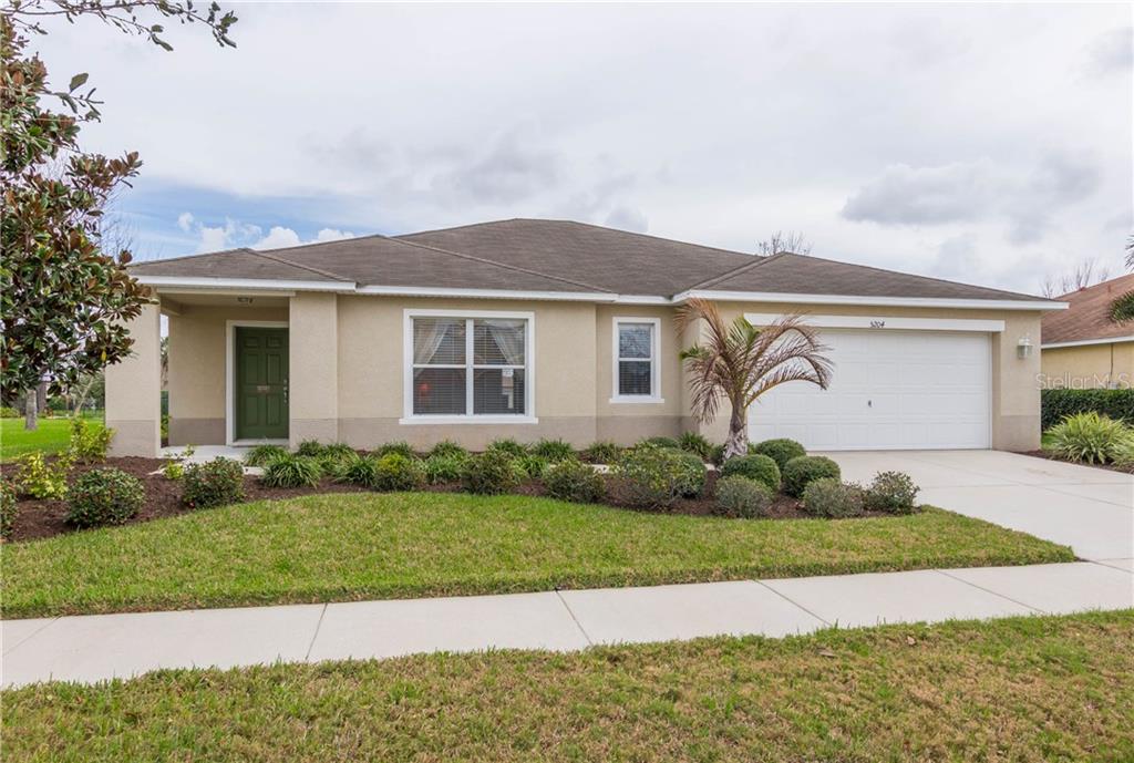 5204 Moon Shell Drive Apollo Beach, FL 33572 - Photo 1 of 1 a front view of a house with a yard and garage