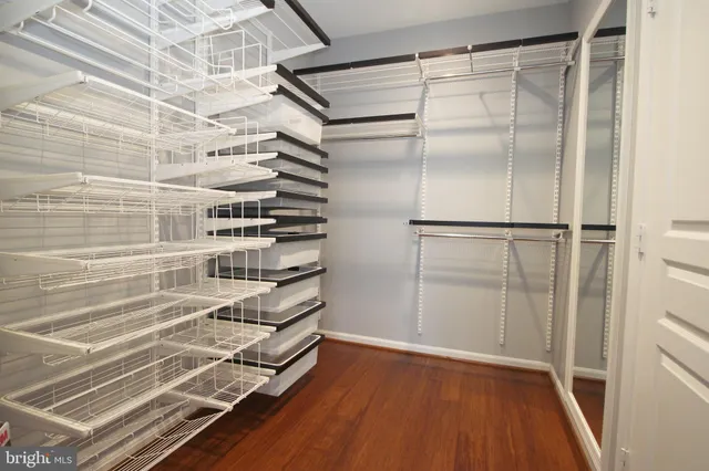 a view of walk in closet with empty racks