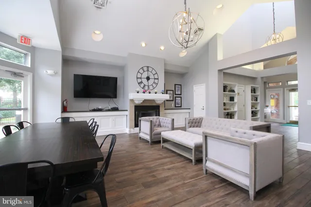 a living room with fireplace furniture and a flat screen tv