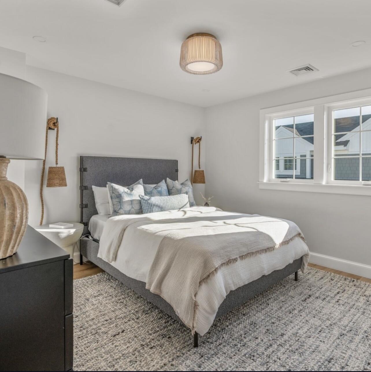 3 Azalea Lane Mashpee, MA 02649 - Photo 19 of 29 a bedroom with a bed and a chandelier