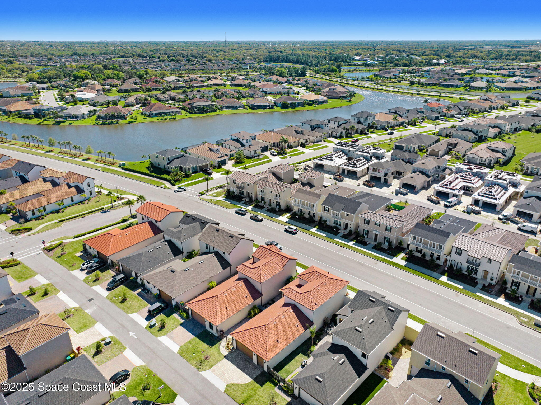 2366 Addison Drive Melbourne, FL 32940 - Photo 11 of 43 an aerial view of a city with lots of residential buildings and ocean view