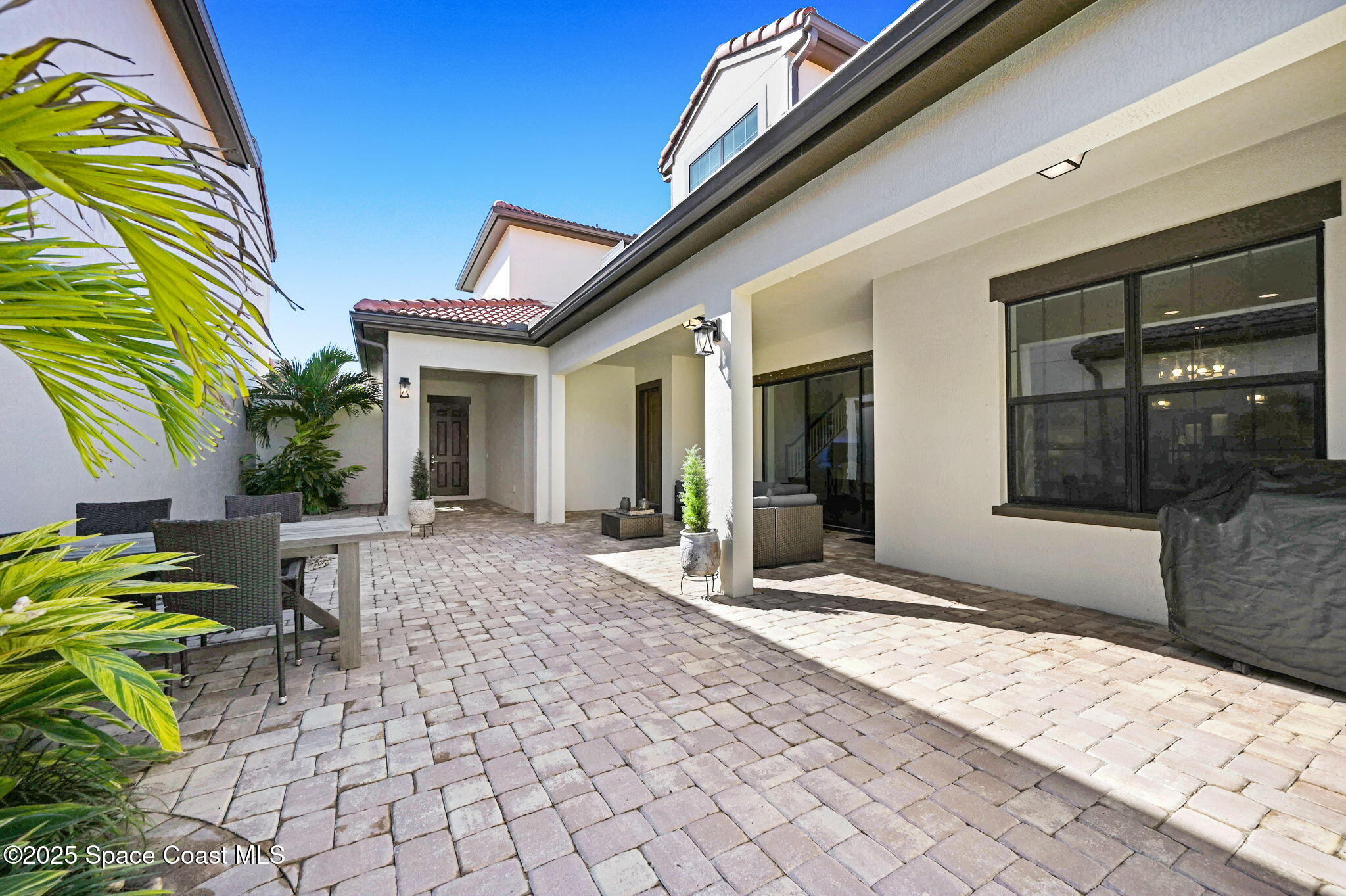 2366 Addison Drive Melbourne, FL 32940 - Photo 21 of 43 a view of house with patio outdoor seating and plants