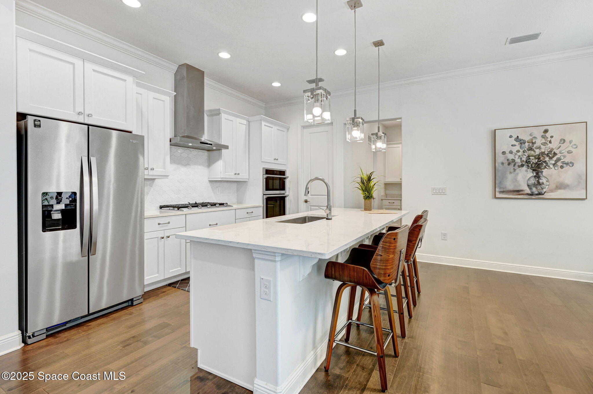 2366 Addison Drive Melbourne, FL 32940 - Photo 25 of 43 a kitchen with stainless steel appliances a dining table chairs refrigerator and microwave