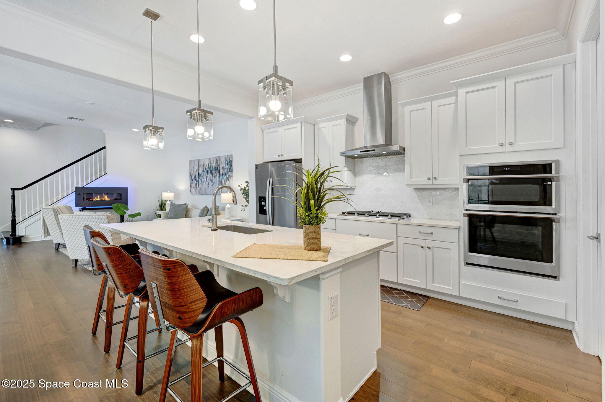 2366 Addison Drive Melbourne, FL 32940 - Photo 26 of 43 a kitchen with stainless steel appliances kitchen island a refrigerator and a stove top oven