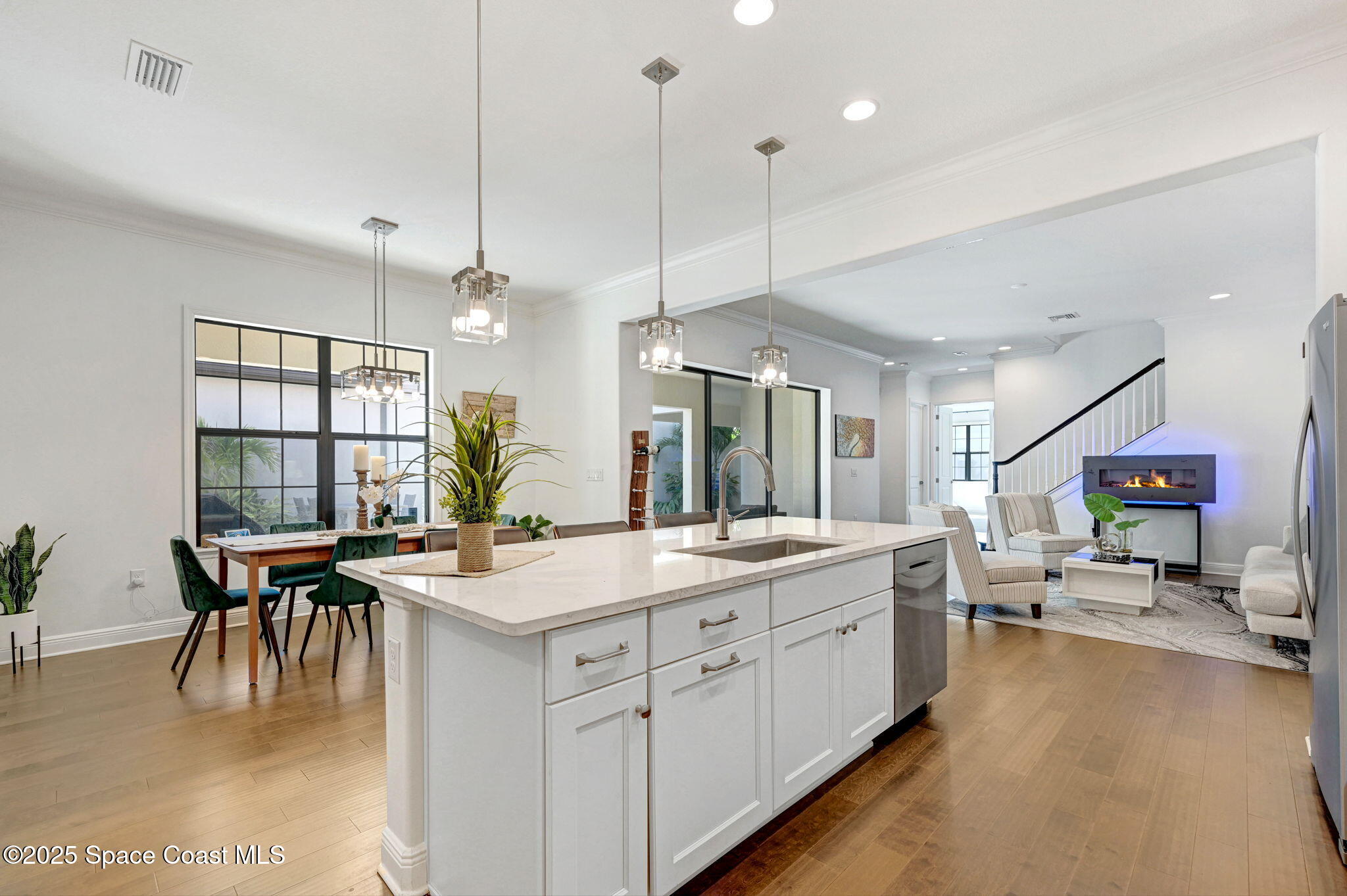 2366 Addison Drive Melbourne, FL 32940 - Photo 27 of 43 a large kitchen with kitchen island a sink stainless steel appliances and a table
