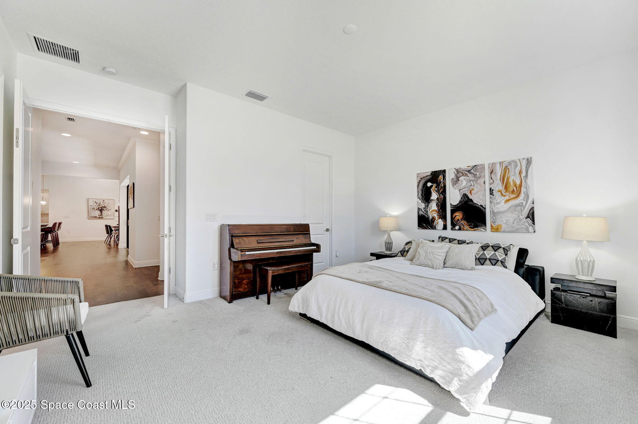 2366 Addison Drive Melbourne, FL 32940 - Photo 33 of 43 a bedroom with a bed and a piano