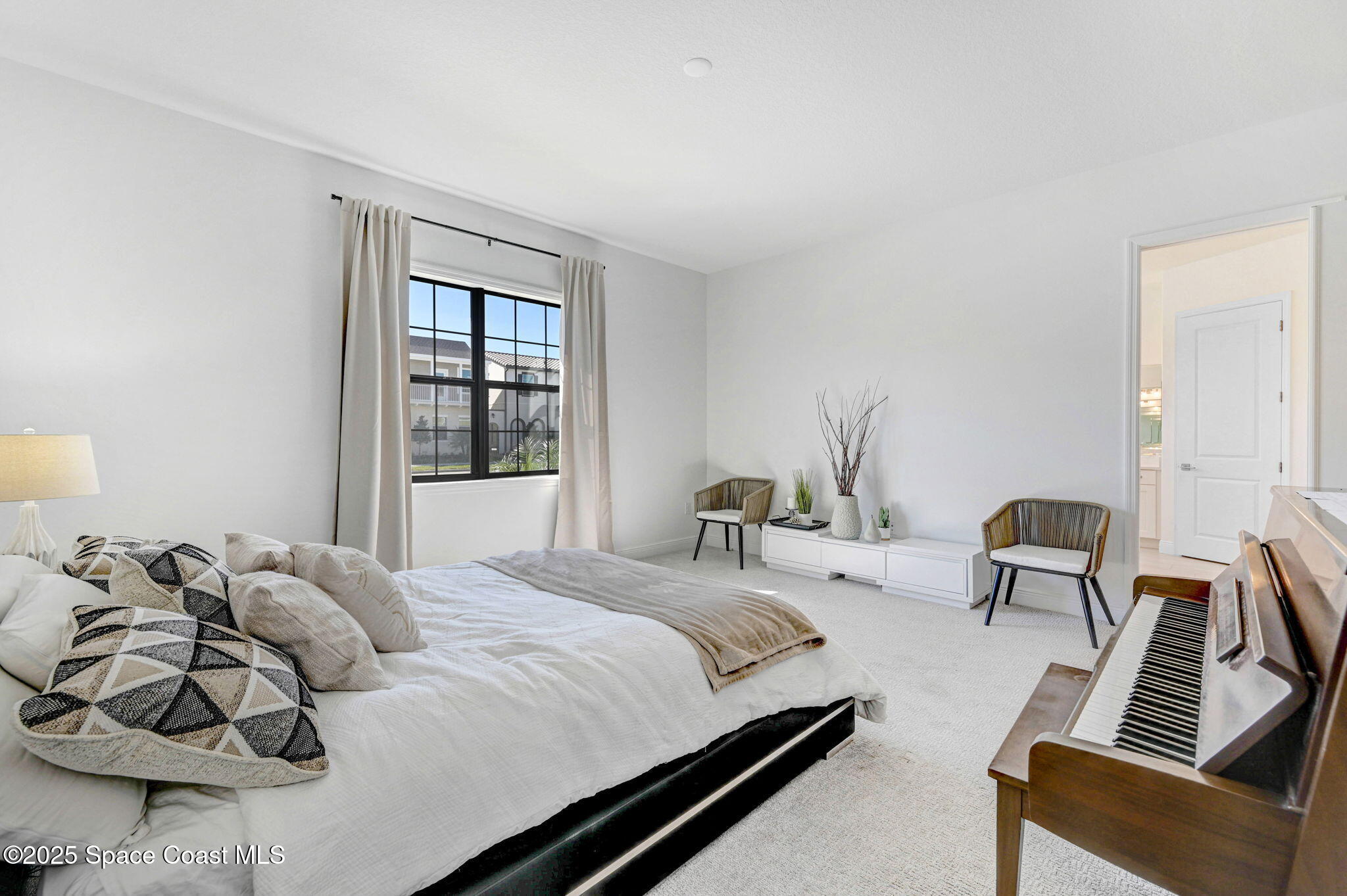 2366 Addison Drive Melbourne, FL 32940 - Photo 34 of 43 a bedroom with a bed and wooden floor