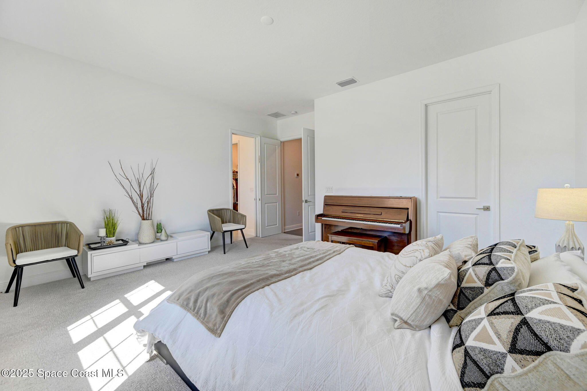 2366 Addison Drive Melbourne, FL 32940 - Photo 35 of 43 a bedroom with a bed and a chandelier