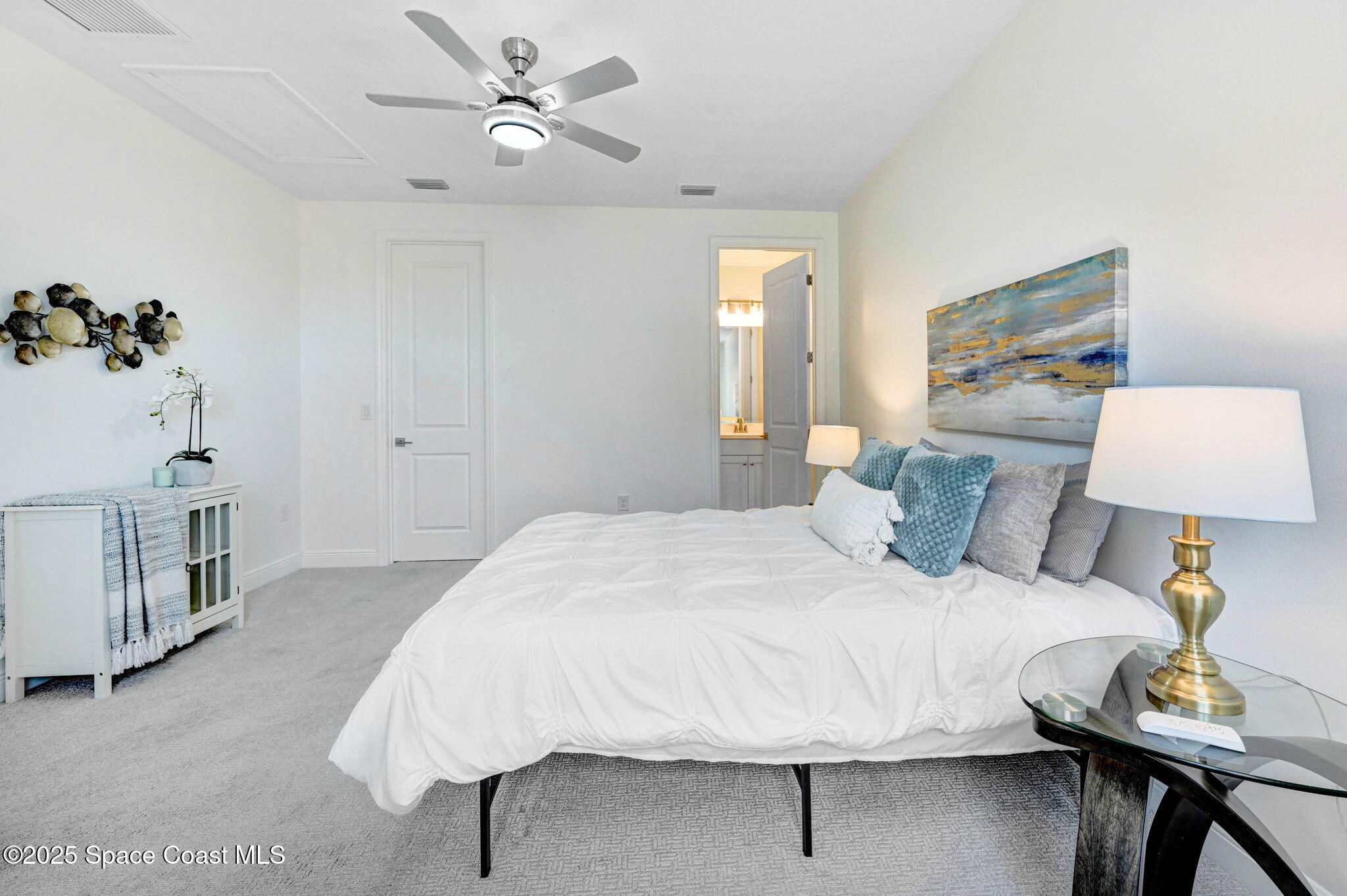 2366 Addison Drive Melbourne, FL 32940 - Photo 39 of 43 a bedroom with a bed and a lamp