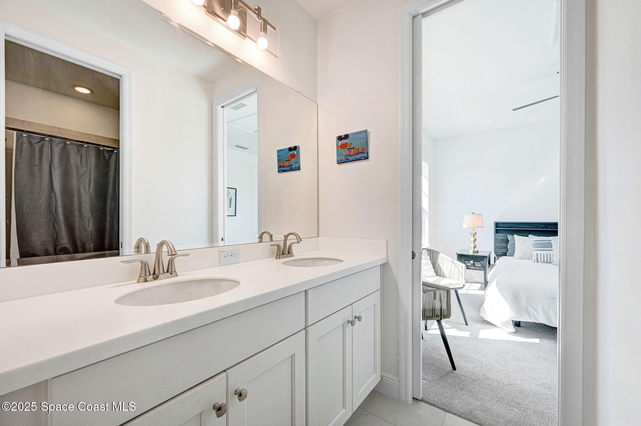 2366 Addison Drive Melbourne, FL 32940 - Photo 41 of 43 a en suite bathroom with a sink double vanity and a mirror