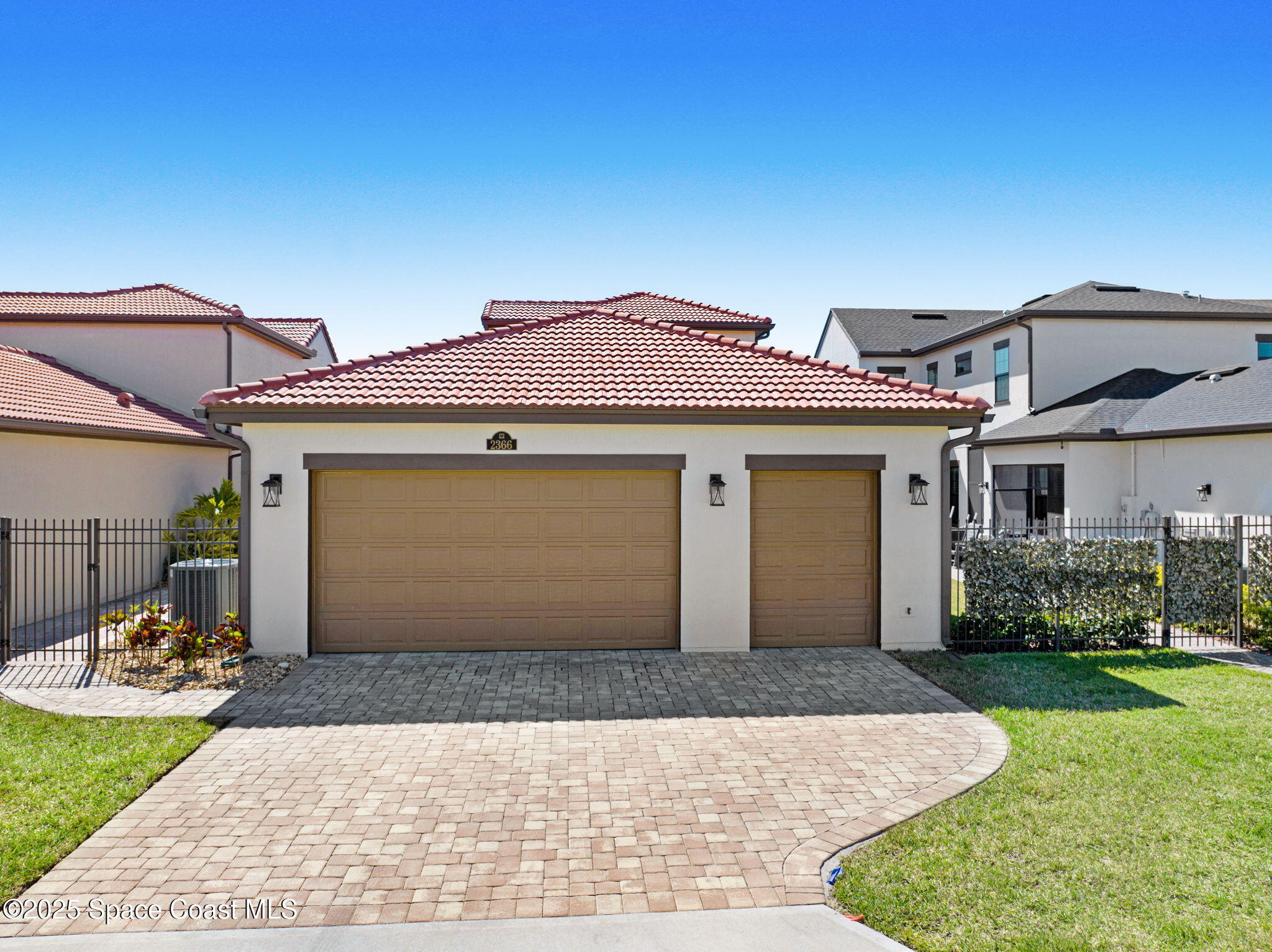 2366 Addison Drive Melbourne, FL 32940 - Photo 9 of 43 a front view of a house with a yard and garage