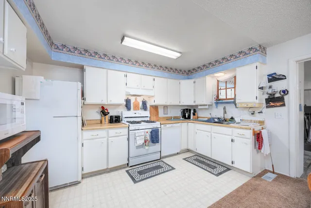 a kitchen with cabinets and appliances