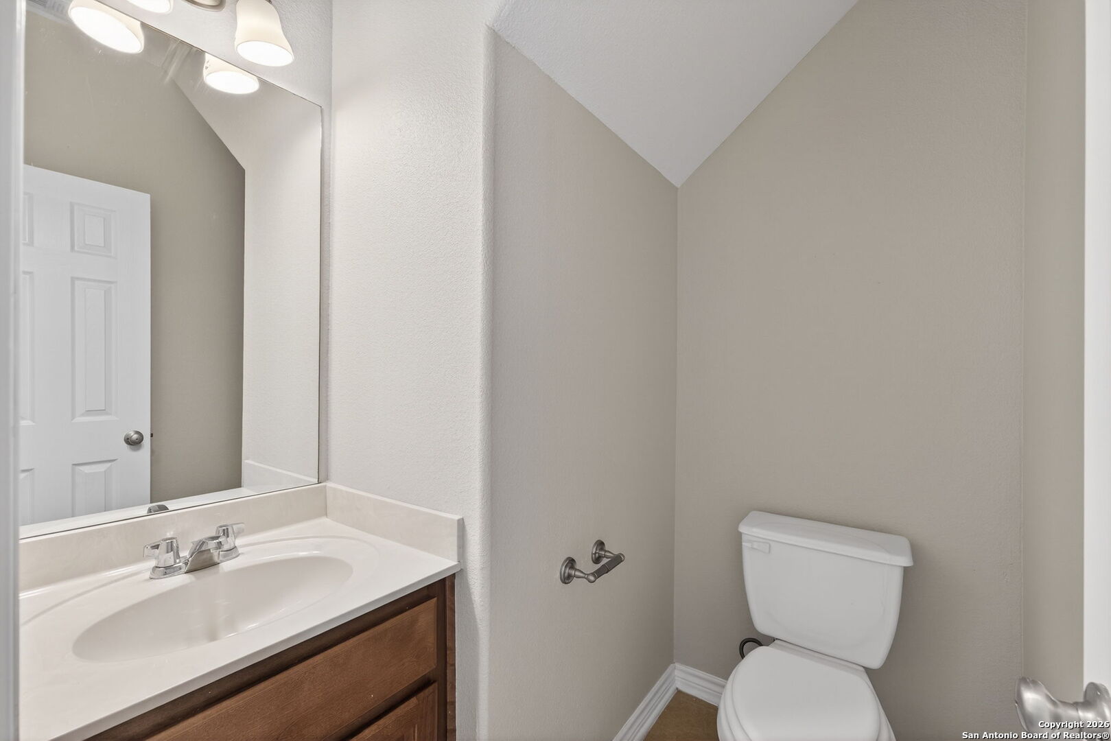 15709 Fair Lane Selma, TX 78154 - Photo 13 of 32 a bathroom with a toilet sink and mirror