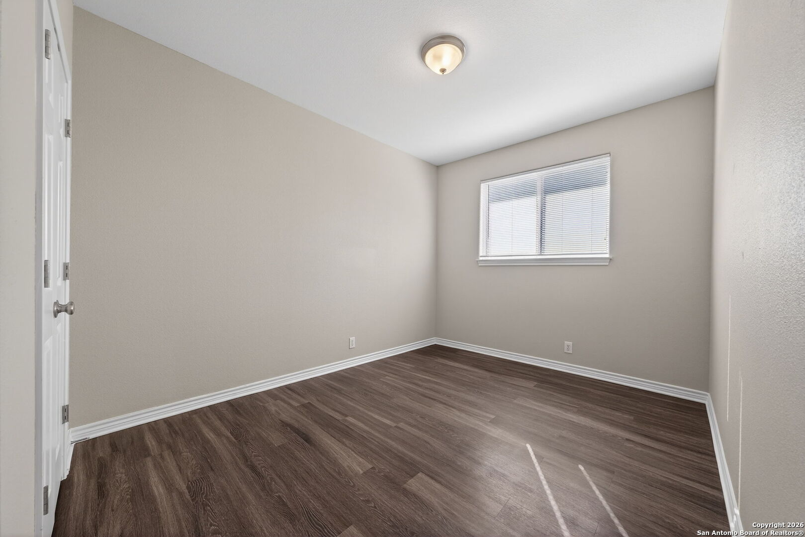 15709 Fair Lane Selma, TX 78154 - Photo 21 of 32 an empty room with wooden floor and windows