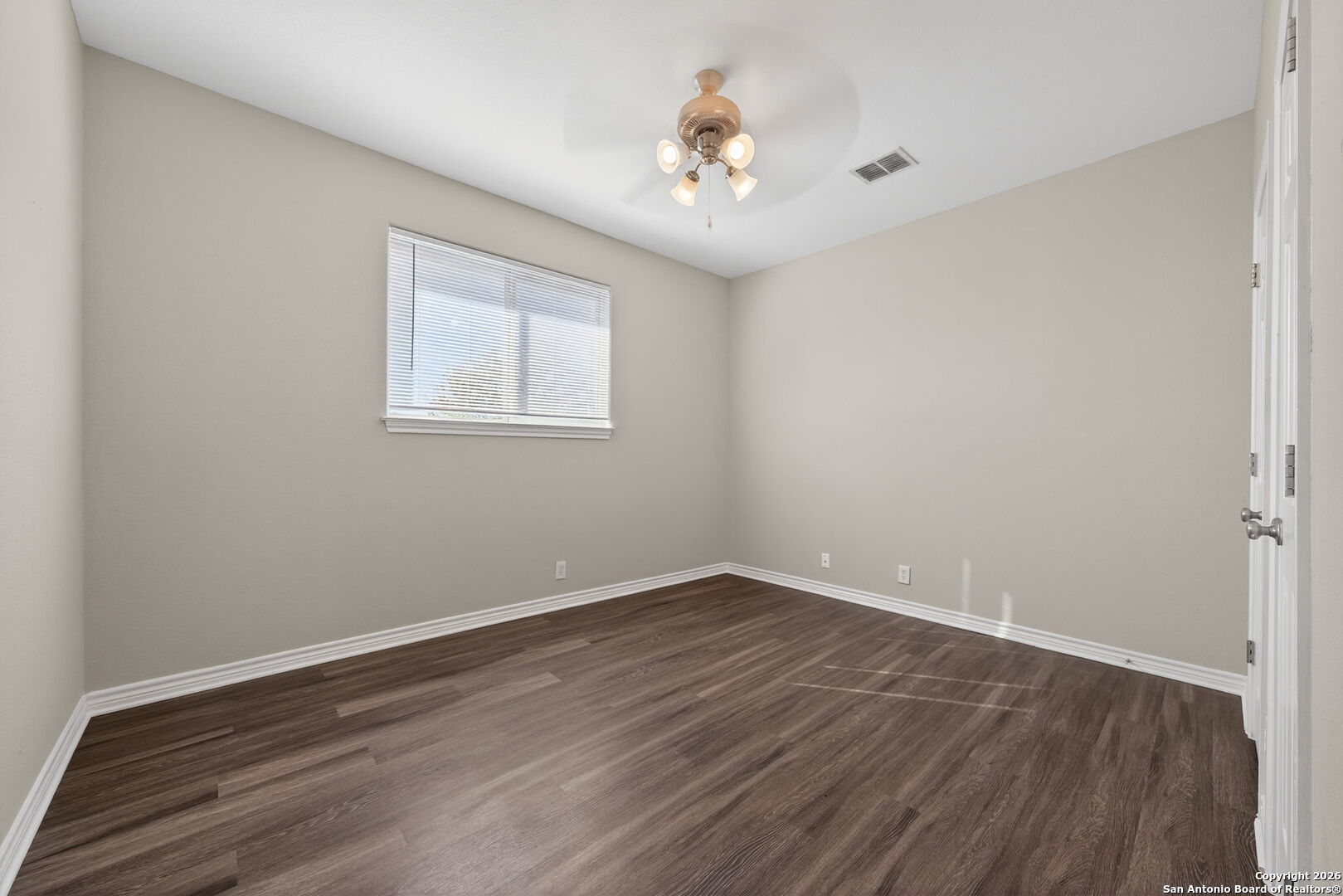 15709 Fair Lane Selma, TX 78154 - Photo 25 of 32 a view of an empty room with wooden floor and a window