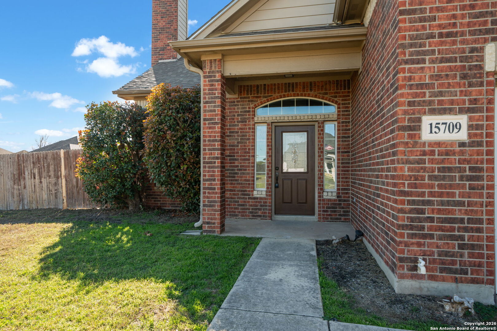 15709 Fair Lane Selma, TX 78154 - Photo 4 of 32 a front view of a house with garden