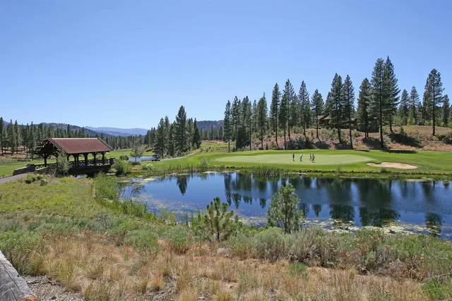 a view of a lake with a house in the background