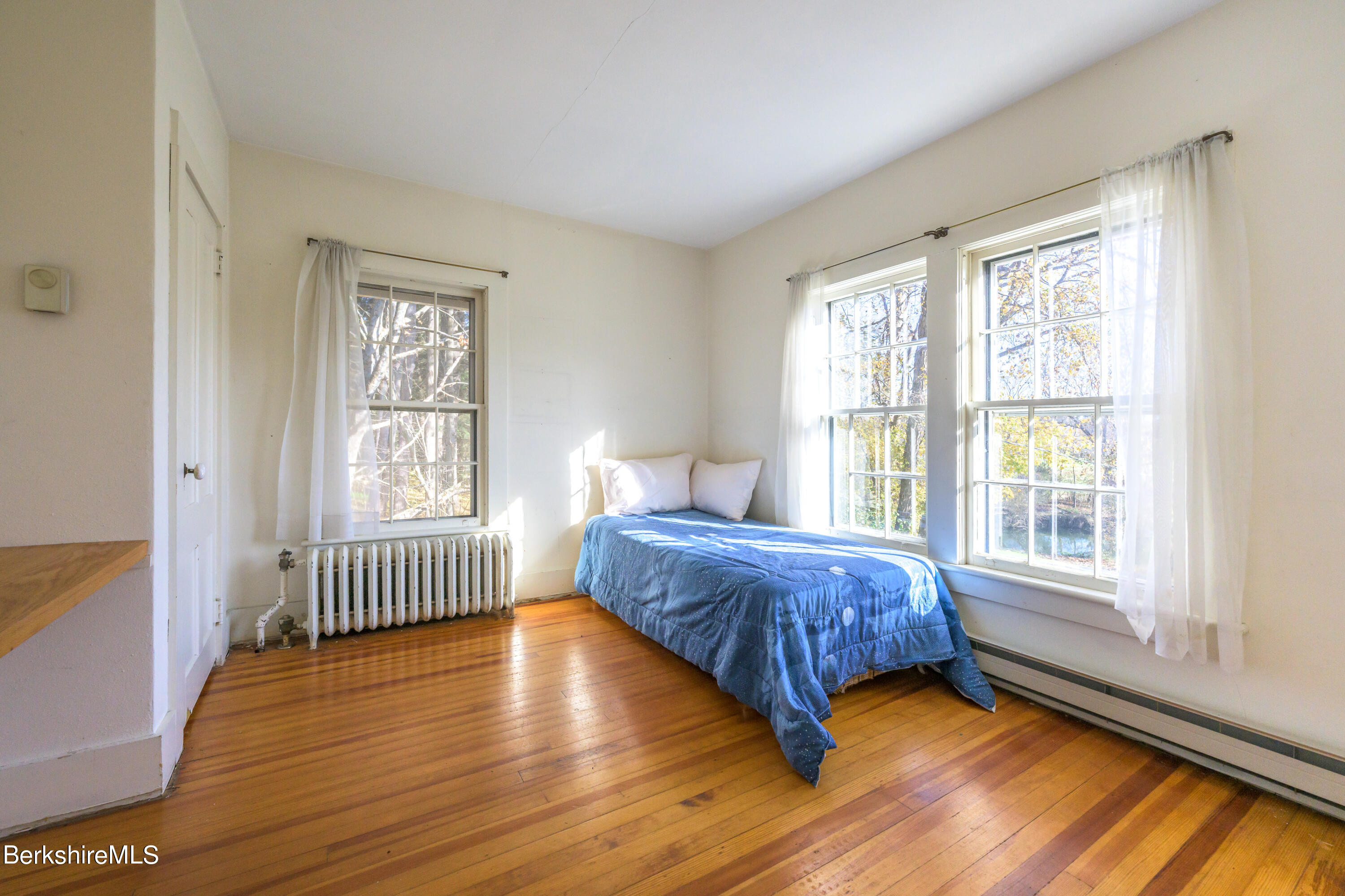 2 Cherry Street Stockbridge, MA 01262 - Photo 34 of 42 a bedroom with a bed and wooden floor