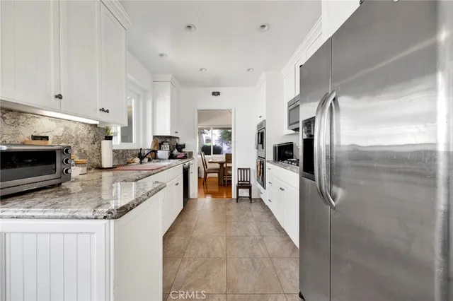 a large kitchen with a large counter top appliances and cabinets