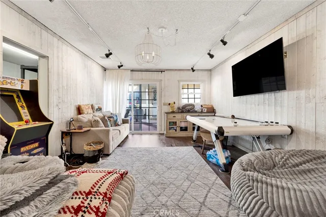 a bedroom with furniture and a flat screen tv