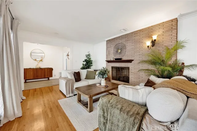 a living room with furniture wooden floor and a fireplace