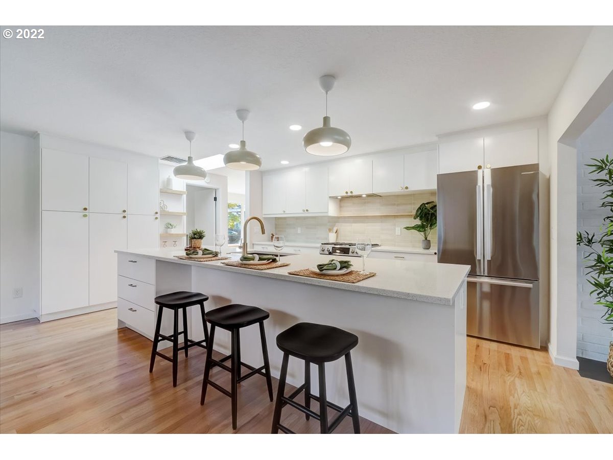 15645 Northwest Perimeter Drive Beaverton, OR 97006 - Photo 11 of 32 a kitchen with refrigerator and chairs