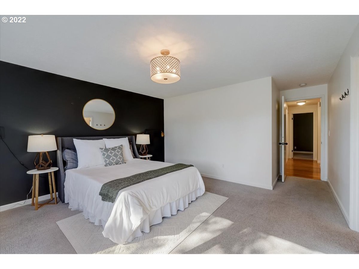 15645 Northwest Perimeter Drive Beaverton, OR 97006 - Photo 18 of 32 a bedroom with a bed and a lamp