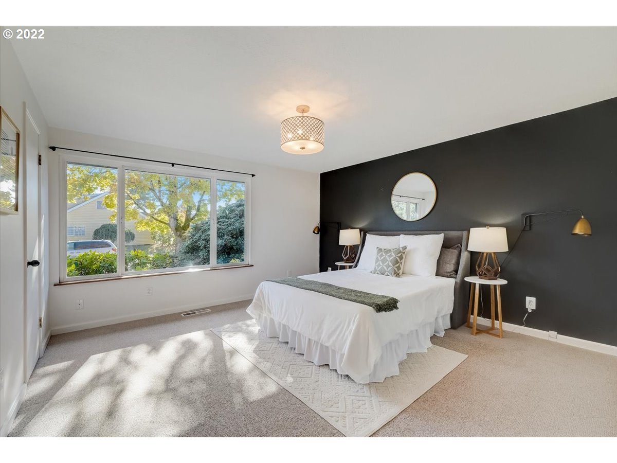 15645 Northwest Perimeter Drive Beaverton, OR 97006 - Photo 19 of 32 a bedroom with a bed and a large window