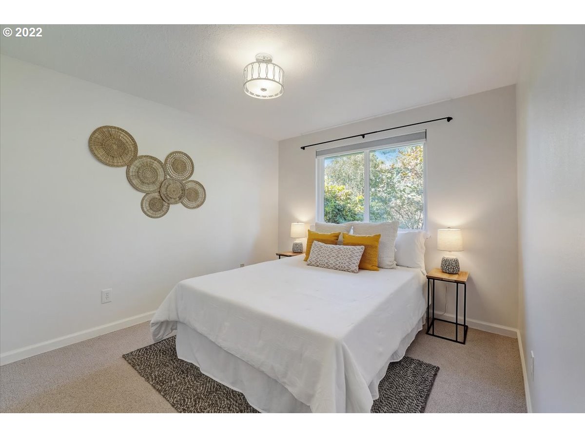 15645 Northwest Perimeter Drive Beaverton, OR 97006 - Photo 22 of 32 a bedroom with a bed and a window