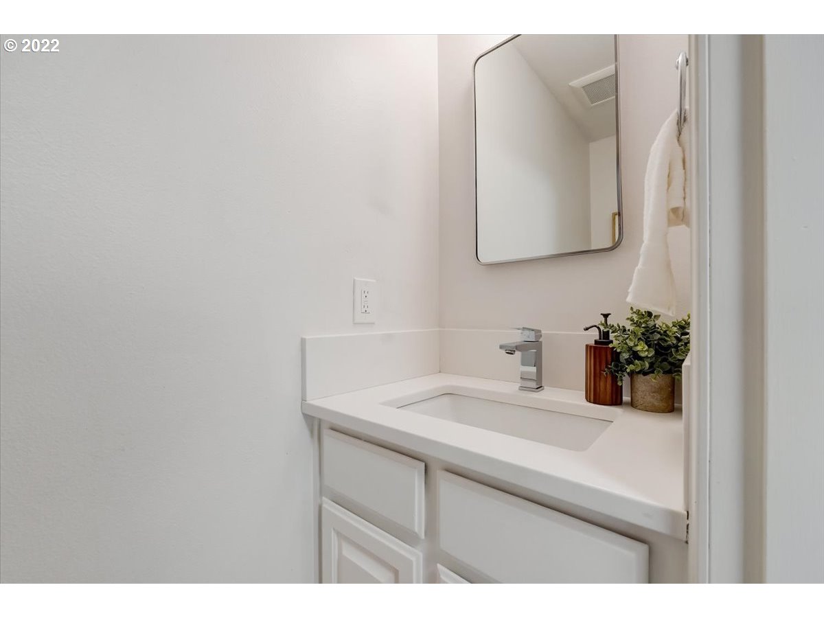 15645 Northwest Perimeter Drive Beaverton, OR 97006 - Photo 27 of 32 a bathroom with a sink vanity and a mirror