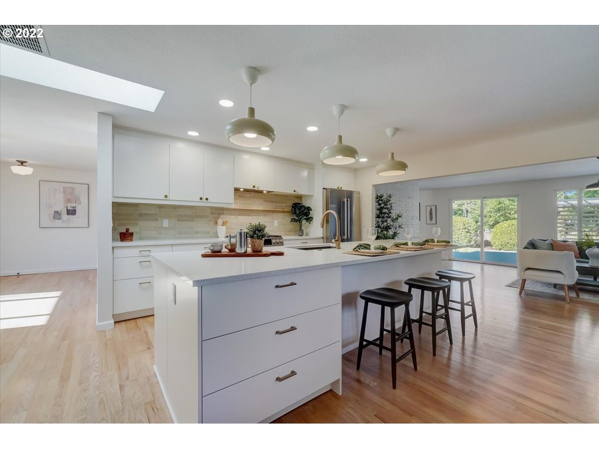 15645 Northwest Perimeter Drive Beaverton, OR 97006 - Photo 10 of 32 a kitchen with stainless steel appliances granite countertop a stove top oven a sink dishwasher and white cabinets with wooden floor