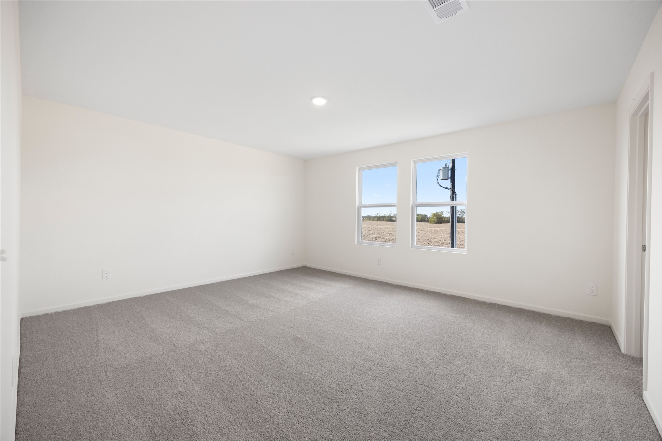 8807 Vacek Xing Way Richmond, TX 77469 - Photo 11 of 33 an empty room with windows and refrigerator