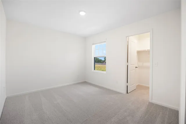 an empty room with a empty space and windows