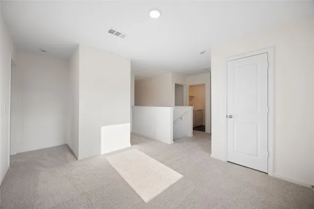 a view of a room with a hallway and stairs