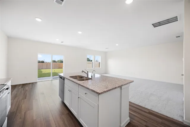 a kitchen with a sink stove and refrigerator