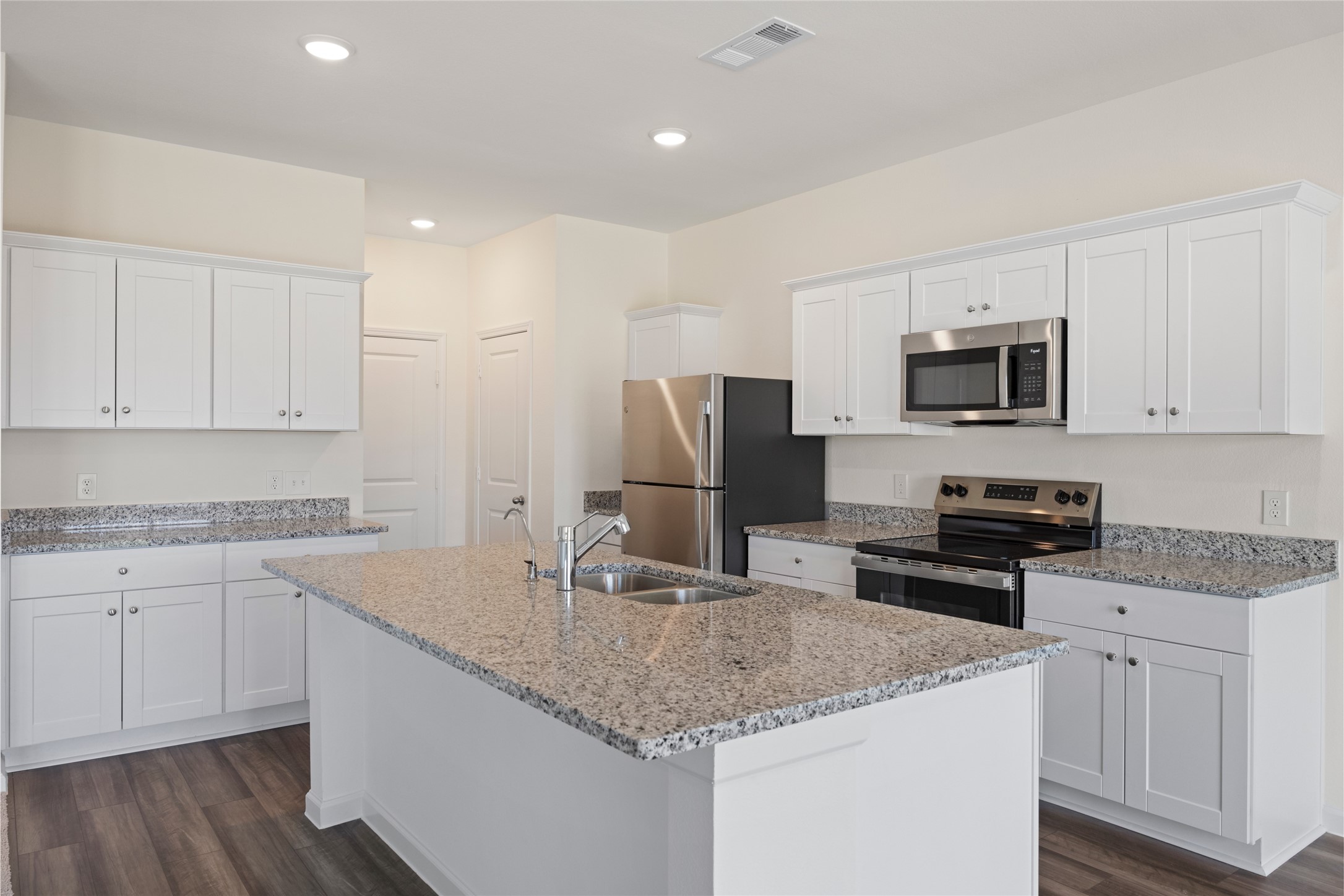 8807 Vacek Xing Way Richmond, TX 77469 - Photo 29 of 33 a kitchen with granite countertop a sink stove and refrigerator