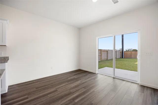 a large kitchen with stainless steel appliances a large counter top a stove and a refrigerator